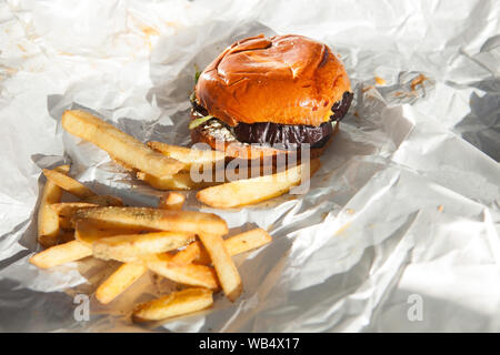 Délicieux hamburger veggie d'aubergines maison avec frites sur fond de papier blanc. Plats végétariens et végétaliens Banque D'Images