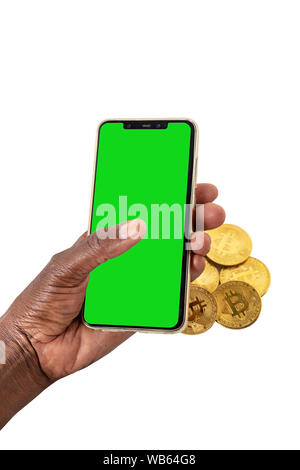 Femme africaine mains tenant une pile de bitcoins et un téléphone avec green , isolated on white Banque D'Images