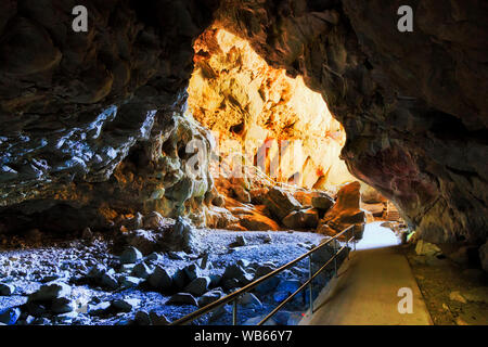 Charlotta énorme grotte passage passage dans des grottes de Jenolan ville de Blue Mountains, Australie. Une piste de marche à travers les rochers vers soleil lointain lumière sous m Banque D'Images