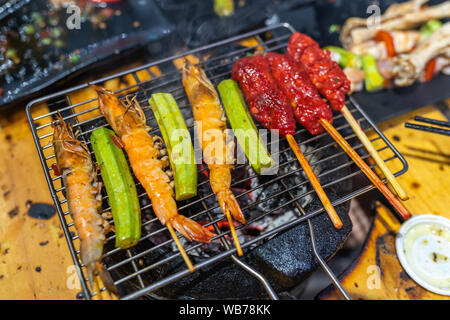 Crevettes grillées et de boeuf avec de l'okra sur un charbon cuisinière Banque D'Images