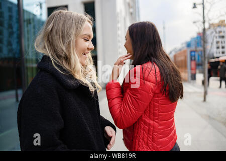 Deux amies s'amuser Shopping dans la ville Banque D'Images