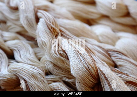 En coton biologique blanc et brun naturel non teint de couleurs. Les chaînes de tissage tissu prêt pour faire Banque D'Images