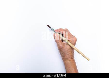 Woman's hand painting avec paintbrush isolé sur fond blanc Banque D'Images