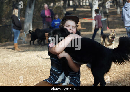 Un jeune garçon embrasse son chien. Banque D'Images