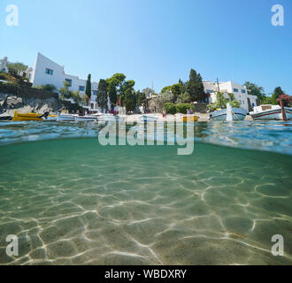 Espagne Portlligat village littoral avec des bateaux et sous-marins de sable, mer Méditerranée et partagé au-dessus et au-dessous de la surface de l'eau, Cadaques, Costa Brava Banque D'Images