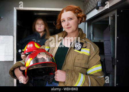 Photo de deux femmes pompiers en camion d'incendie à la station Banque D'Images