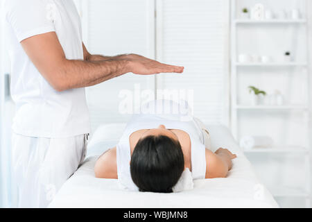 Portrait de guérisseur mettant les mains au-dessus du ventre de femme enceinte Banque D'Images