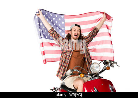 Heureux jeune homme assis sur un scooter rouge et holding American flag on air isolated on white Banque D'Images