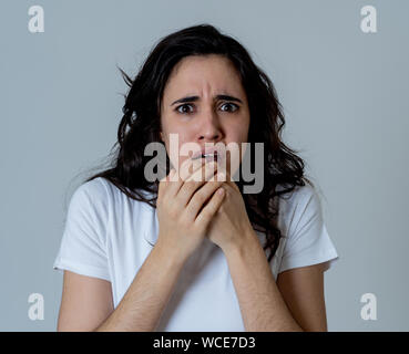 Portrait de jeune femme latine sentiment effrayé et choqué de faire peur, l'anxiété des gestes. Terrifié à la couvrant elle-même. Copier l'espace. En négatif hu Banque D'Images