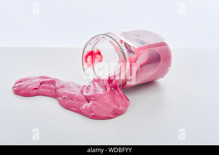 Appelé jouet Slime déversant du pot sur fond blanc Banque D'Images