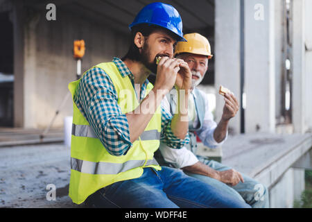 Mature et jeune ingénieur, architecte, travailleur assis à chantier et de repos Banque D'Images