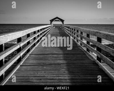 La ville de Waimea pier au coucher du soleil pris avec de longs temps d'exposition utilisée pour lisser et estomper l'océan. Banque D'Images