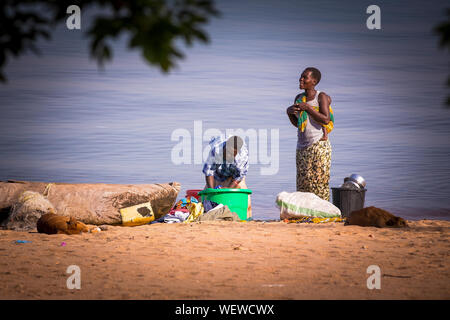 Le Lac Malawi Monkey Bay Femme Porter Son Bebe A Laver Les Vetements A La Plage Sud Sud Photo Stock Alamy