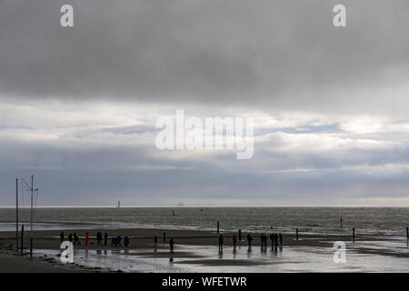 Norderney, Weststrand, Menschengruppe, dunkle Wolken, Horizont, Fähre Banque D'Images