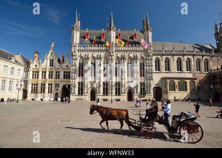 Belgique, Flandre occidentale, Bruges, centre historique classé au Patrimoine Mondial de l'UNESCO, la vieille ville, l'hôtel de ville (Stadhuis) et 14e siècle façade en pierre de style gothique, balade en calèche Banque D'Images