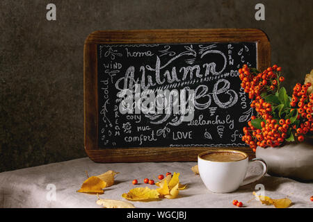 Tasse de café expresso et vintage tableau lettrage manuscrit sur le linge de table cloth avec l'automne jaune feuilles et baies en vase en céramique. The w Banque D'Images