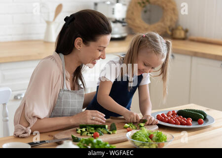 Mère fille enseigne à cuisiner une salade de légumes Banque D'Images