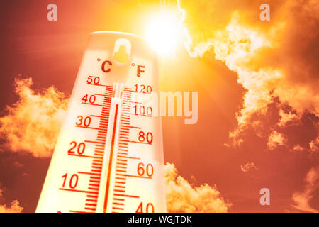 Thermomètre en face d'un ciel avec soleil et nuages Banque D'Images