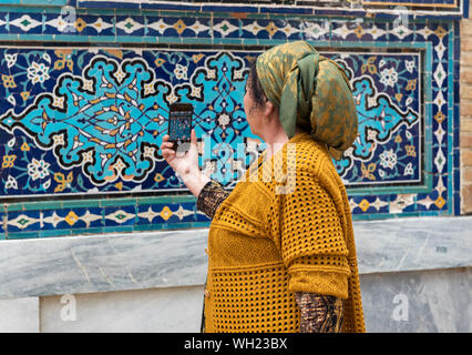 Femme ouzbek prend des photos de mosaïques à Shah-i-Zinda (Shohizinda) nécropole, Samarkand, Ouzbékistan Banque D'Images