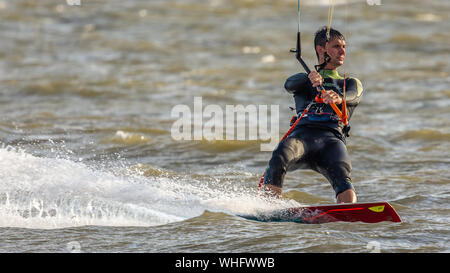 L'homme le kitesurf dans la mer à Llanelli, Carmarthenshire, Pays de Galles. UK. Banque D'Images