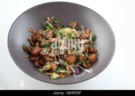 Salade de légumes feuilles et santé avec le saumon sur un plat moderne gris sur fond de table en bois blanc. Les poissons gras-les meilleurs aliments pour les athlètes de bonnes sources de protéines maigres et acides gras oméga-3. Banque D'Images