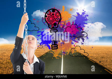 Image composite de blond businesswoman pulling une chaîne Banque D'Images