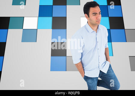 Composite image of unsmiling casual man standing Banque D'Images