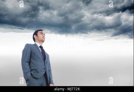 Composite image of unsmiling businessman standing Banque D'Images