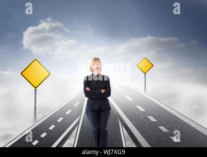 Composite image friendly businesswoman smiling at the camera in a meeting Banque D'Images