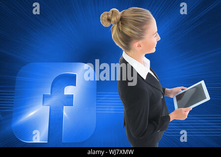 Image composite de blond businesswoman holding new tablet Banque D'Images