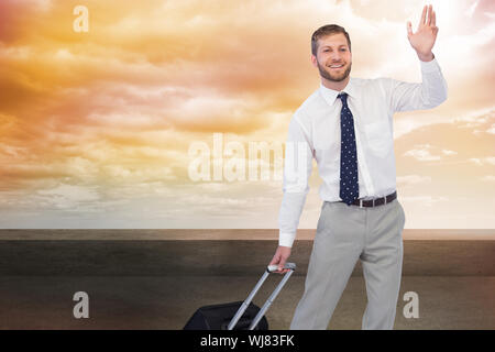 Image composite de handsome businessman with suitcase waving Banque D'Images