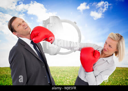 Image composite de businesswoman boxing gloves on white background Banque D'Images