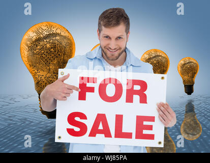 Composite image of model holding a for sale sign on white background Banque D'Images