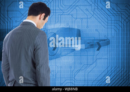 Composite image of unsmiling businessman standing Banque D'Images