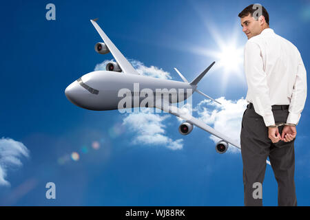 Image composite de froncer businessman wearing handcuffs Banque D'Images