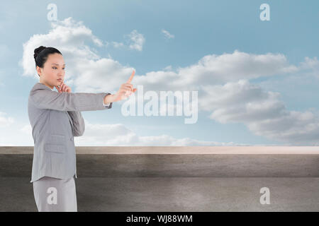 Composite image of businesswoman pointing Banque D'Images