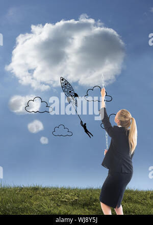 Image composite de blond businesswoman pulling une chaîne Banque D'Images