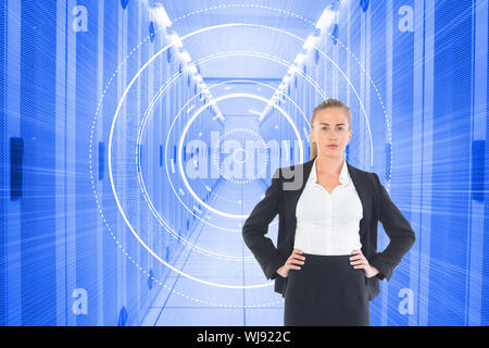 Image composite de blond businesswoman standing with hands on hips Banque D'Images