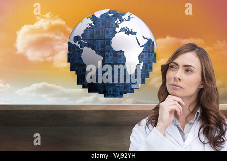 Composite image of thoughtful brunette doctor looking away Banque D'Images