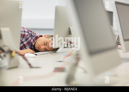 Handsome student sieste dans la salle informatique Banque D'Images