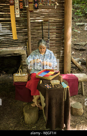 CHEROKEE, USA-Juin 17, 2017 : femme Cherokee non identifiés ne perlage traditionnel dans la région de Cherokee, Caroline du Nord. Banque D'Images