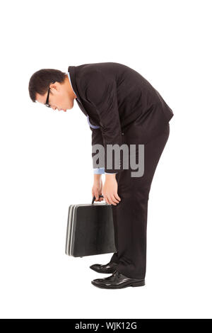 Indolent businessman stoop et holding briefcase Banque D'Images