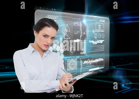 Elegant young businesswoman with clipboard contre porte sur fond noir technologique Banque D'Images
