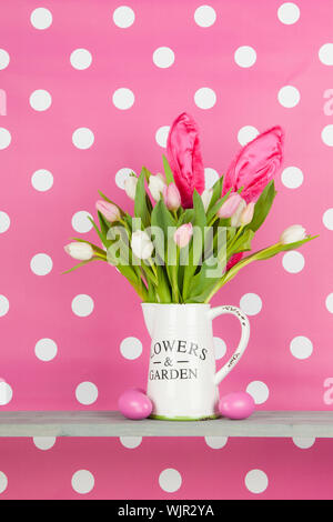 Bouquet de pâques avec les oreilles du lièvre et œufs sur dotted background rose Banque D'Images