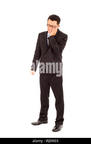 Young businessman standing et dans l'agonie d'un mal de dents Banque D'Images