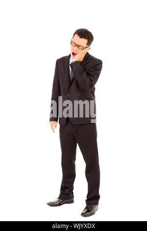 Young businessman standing et dans l'agonie d'un mal de dents Banque D'Images