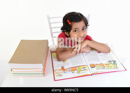 Girl reading a book and smiling Stock Photo