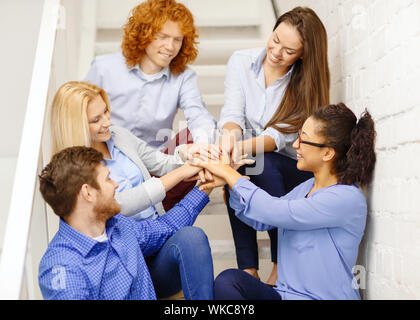 Avec l'équipe de mains sur le dessus de l'autre on staircase Banque D'Images