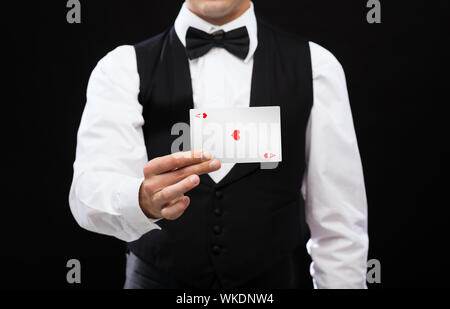 Dealer holding white card Banque D'Images