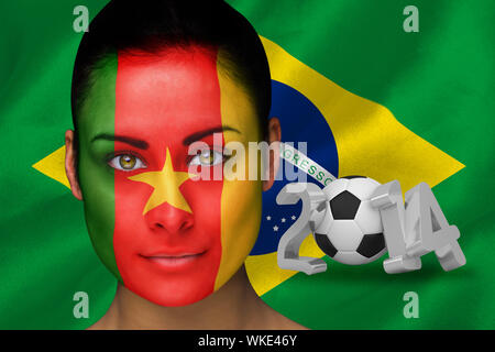 Image composite du Cameroun de football dans la peinture pour le visage contre coupe du monde 2014 avec brasil flag Banque D'Images